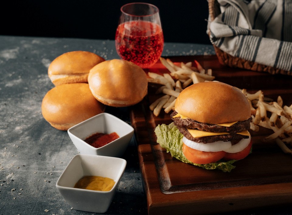 Classic burger with fries on a wooden board
